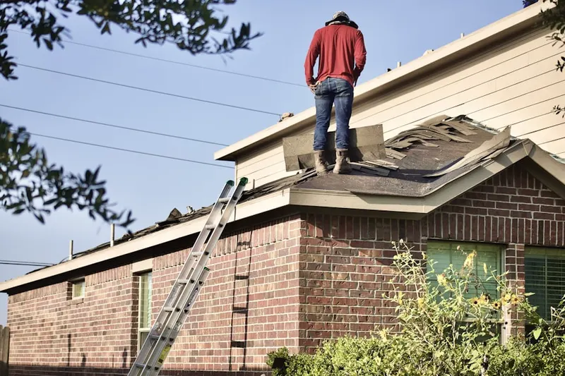 Professional roofer working on a residential roof in Conaway